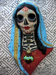 a cake shaped like a woman with blue hair and skeleton makeup on it's face