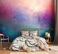 a bedroom with colorful galaxy wallpaper in the background