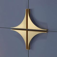 a close up view of a metal object against a blue wall with lines on it