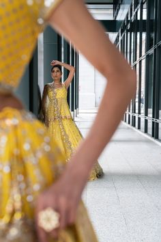 Aleanor Yellow Lehenga Choli- Hand Sequence, Mirror, Beads Embroidery Introducing our stunning Aleanor Yellow Lehenga Choli, a masterpiece of artistry and elegance. This exquisite ensemble is adorned with meticulous hand sequence, mirror, and bead embroidery, creating a breathtaking visual spectacle. Immerse yourself in the enchantment of this ensemble, designed to make you feel like a true vision of grace and beauty. Yellow Blouse with Spaghetti Strap Neckline Spaghetti Strap Neckline gives thi Hand Embellished Lehenga For Wedding And Transitional Seasons, Festive Yellow Hand Embellished Set, Festive Hand Embellished Yellow Set, Elegant Embellished Yellow Sets, Elegant Yellow Embellished Sets, Elegant Yellow Lehenga With Mirror Work, Fusion Style Festive Wedding Sets, Fusion Style Wedding Sets For Festive Occasion, Festive Fusion Wedding Sets