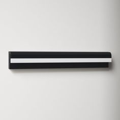 a black and white wall mounted shelf with two horizontal stripes on it's sides