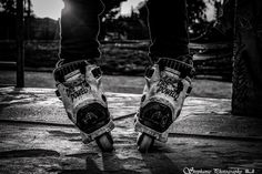 black and white photograph of someone's feet on roller skates