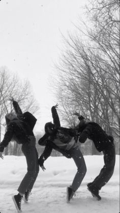 three people are doing tricks in the snow