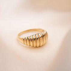 14k Solid Gold Ribbed Dome Ring We're loving the vintage charm, and the lined texture of our new Ribbed Dome Ring. This piece is ideal for good times but simple enough to wear every day. Handmade in California. Worn everywhere. Material: Solid 14k Gold Luxury Adjustable Gold Dome Ring, Classic Gold Jewelry With Fluted Bezel, Vintage 14k Gold Stackable Jewelry, Vintage Stackable 14k Gold Jewelry, Brass Rings With Polished Finish For Wedding, Gold Vintage Dome Ring With Round Band, Vintage Gold Dome Ring With Round Band, Vintage Gold Dome Ring, Classic Brass Dome Ring For Anniversary