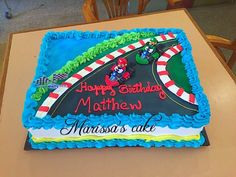 a birthday cake with mario kart driving on the road and happy birthday mother's day written on it