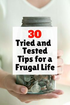 a woman holding a jar full of coins with the words 30 tried and tested tips for a frugal life