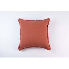 an orange pillow on a white background