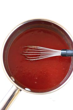 the recipe for homemade ketchup is in a pot with a whisk