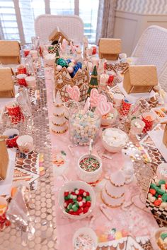 a table is set up with candy, cookies and candies for a christmas party