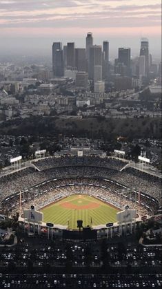 an aerial view of a baseball stadium with the city in the background