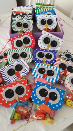 an assortment of owl candy boxes on a table