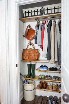 an open closet with shoes, bags and handbags