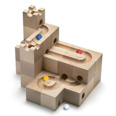 the wooden blocks are stacked on top of each other with different shapes and materials in them