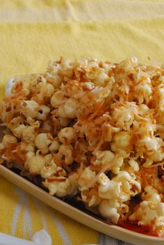 a plate full of popcorn sitting on a table