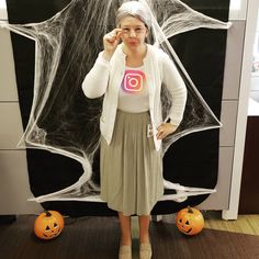 a woman standing in front of a halloween decoration