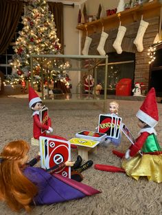 there are three elfs playing with toys in the living room