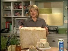 a woman holding up a large piece of cheese