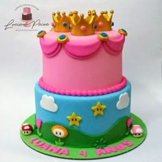 a pink and blue cake with a crown on top