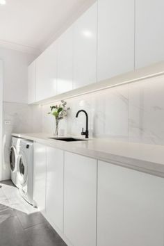 a washer and dryer in a white kitchen