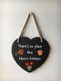 there is no place like mum's kitchen hanging on the wall with a heart