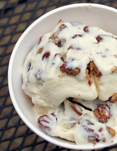 a white bowl filled with ice cream covered in nuts