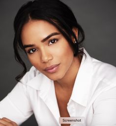 a woman in a white shirt posing for a photo