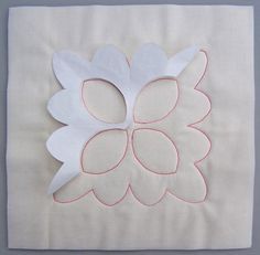 a piece of white paper with pink trim on it and a flower in the middle