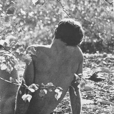 black and white photograph of a naked man in the woods