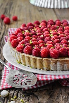 a tart with raspberries is on a plate