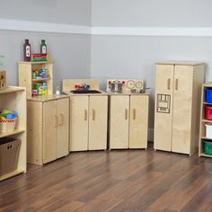 a room filled with lots of wooden toys and storage containers on top of hard wood flooring