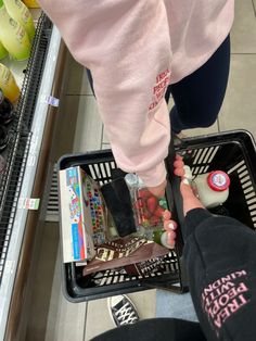 a person standing in front of a basket filled with items