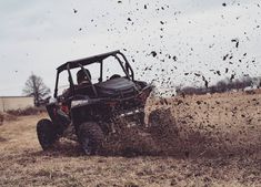 a person riding on the back of a polaris rzr s4 in the mud