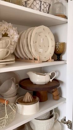 the shelves are filled with dishes and plates