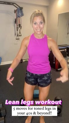 a woman standing in front of a gym machine with her arms spread out and smiling