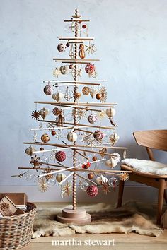 a wooden christmas tree with ornaments on it