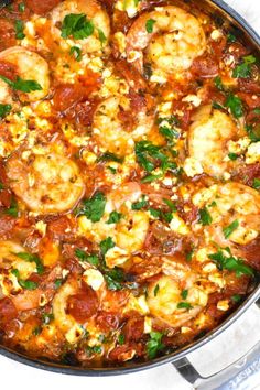 a pan filled with shrimp and tomato sauce