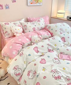 a bed with hello kitty sheets and pillows