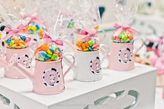 candy in mugs are sitting on a table