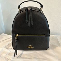 Never Used - Coach Jordyn Backpack - Black - Gold Hardware Coach Backpack Jordyn, Coach School Backpack With Zipper Closure, Black Backpack With Gold-tone Hardware For On-the-go, Black Backpack With Gold-tone Hardware, Modern Backpack With Gold-tone Hardware, Black Backpack With Gold-tone Hardware For Travel, Coach Black School Backpack, Black Backpack With Gold-tone Hardware For Daily Use, Black Standard Backpack With Gold-tone Hardware