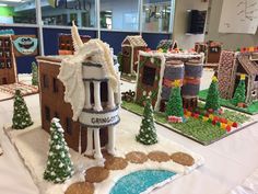 gingerbread houses are displayed on a table