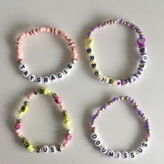 four bracelets with words written on them