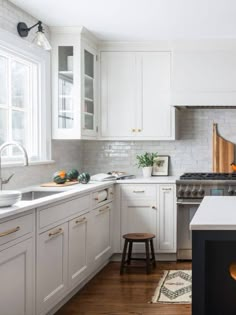 the kitchen is clean and ready for us to use it's white cabinetry