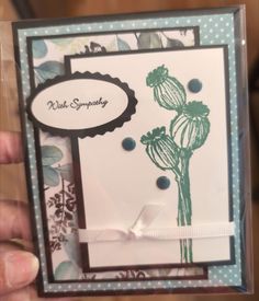 a hand holding up a card with flowers on it