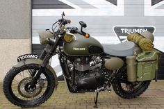 a green motorcycle parked in front of a building