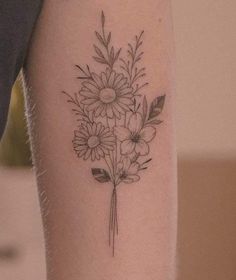 a black and white photo of a flower tattoo