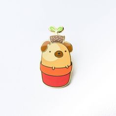 a pin with a dog on it's head and a plant growing out of its top