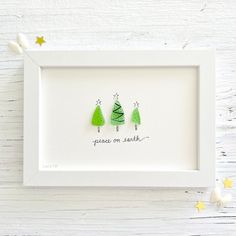 three green christmas trees with the words peace on earth written below them in black ink