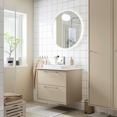 a bathroom with a sink, mirror and towel rack