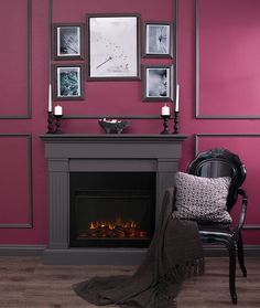 a living room with a fire place, chair and pictures on the wall above it