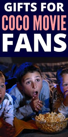 three children laying on the floor with their mouths open and popcorn in front of them